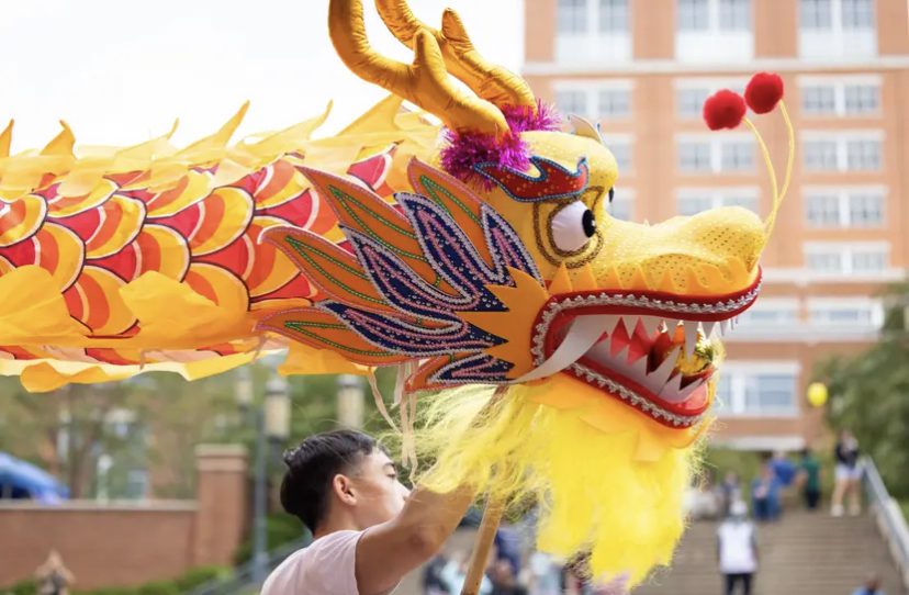 Image of student holding dragon puppet.